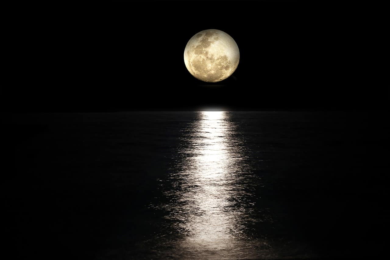 photo of the moons reflection over water
