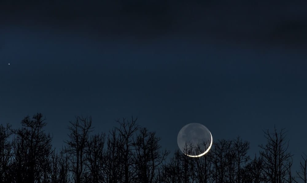 Earthshine illuminating most of the Moon