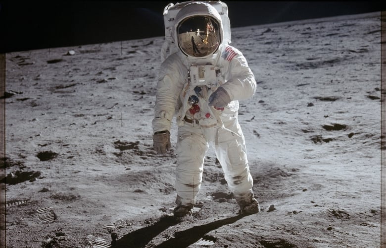 Astronaut Edwin Aldrin walks on lunar surface near leg of Lunar Module