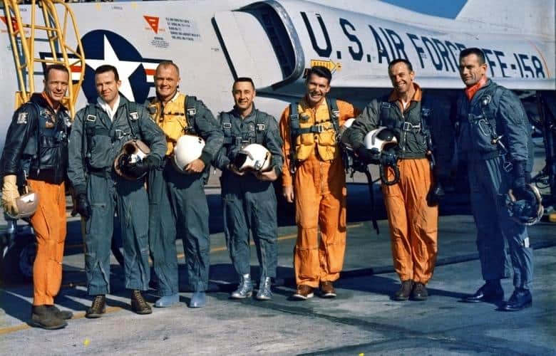 The Original Seven Mercury Astronauts pose beside an Air Force F-102 jet